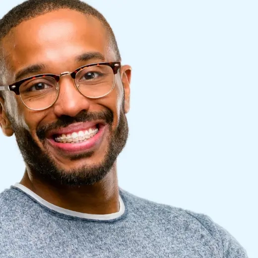 man with braces smiling - Louisiana Orthodontic Specialists