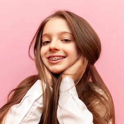 child with braces smiling